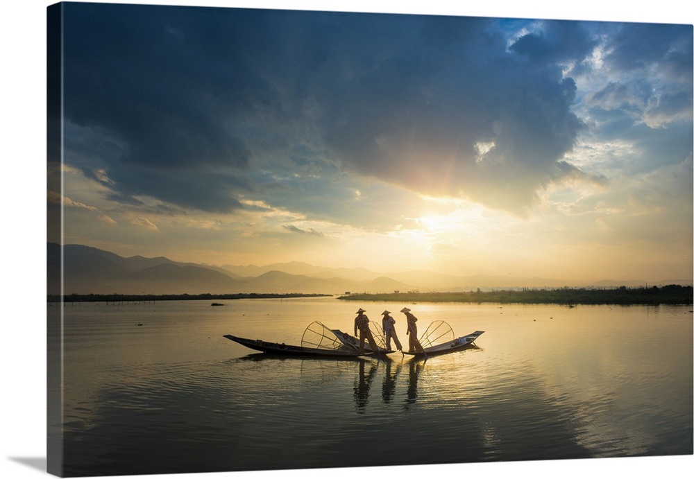 Myanmar, Shan, Nyaungshwe, Inle Lake, Taunggyi district, Three local fishermen in silhouette at sunrise