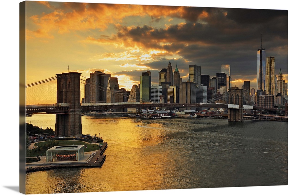 USA, New York City, East River, Manhattan, Brooklyn Bridge, Downtown skyline at sunset, view from the Manhattan Bridge wal...