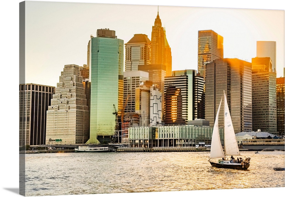 New York City, Lower Manhattan financial district and sailboat viewed from Brooklyn..