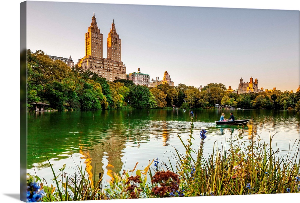 USA, New York City, Manhattan, Central Park, Rowing on the Lake with the San Remo building in the background.