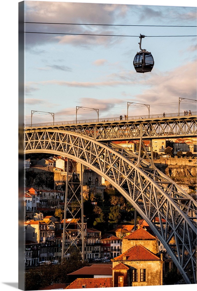 Portugal, Porto, Cable car over the bridge at sunset.
