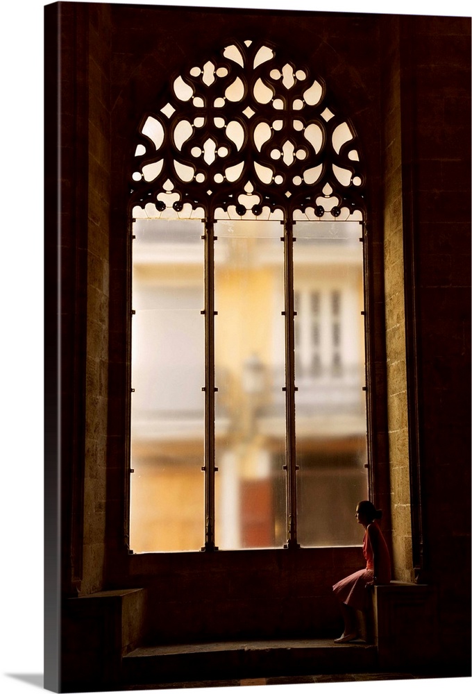 Spain, Comunidad Valenciana, Valencia, Hall of Lonja de La Seda, Woman sitting by a window