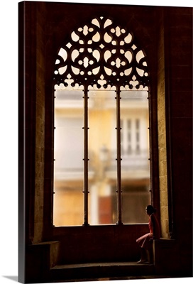 Spain, Valencia, Hall of Lonja de La Seda, Woman sitting by a window