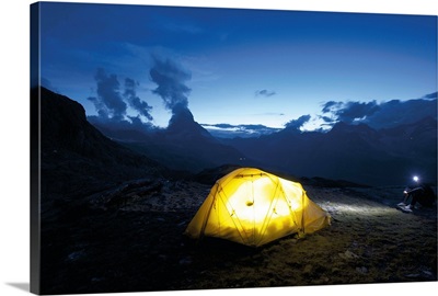 Switzerland, Valais, Alps, glowing light from tent in the wilderness