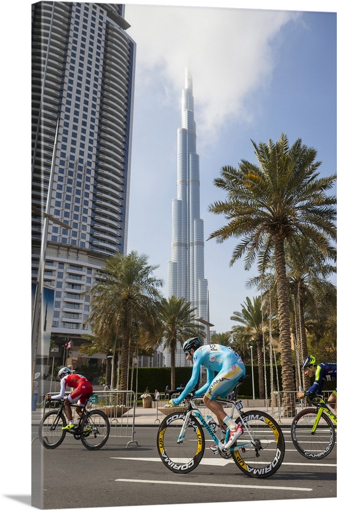 United Arab Emirates, Dubai, Dubai City, Touring cyclists pass the Burj Khalifa.