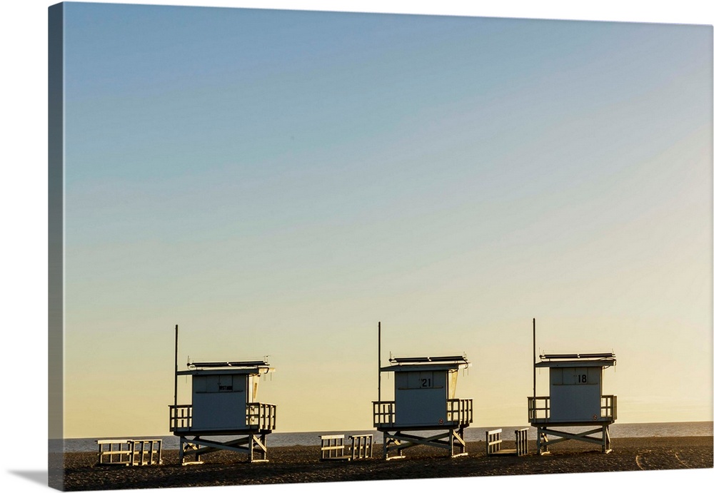 USA, California, Los Angeles, Venice Beach, Lifeguard towers at sunset.