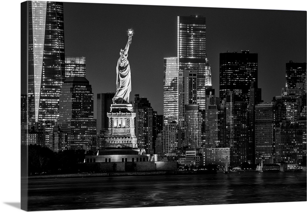 USA, New York City, Lower Manhattan, Lower Manhattan skyline and Statue of Liberty at night.