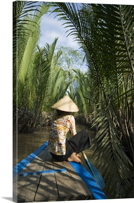 Vietnam, My Tho, Mekong Delta, woman rows among the channels of Dragon island