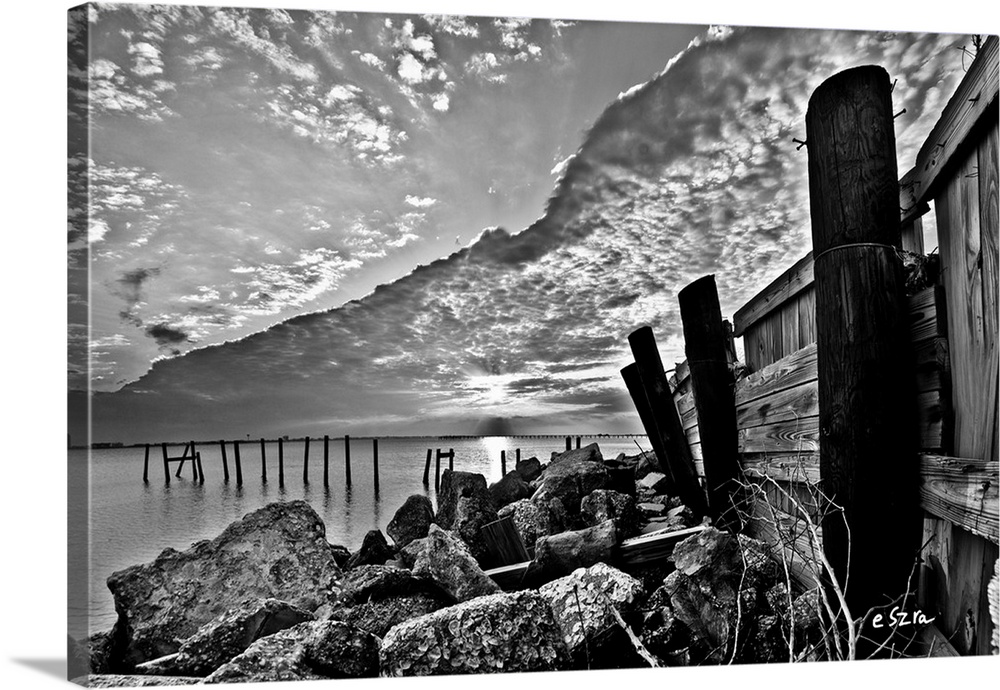 A broken sea wall in vintage black and white.