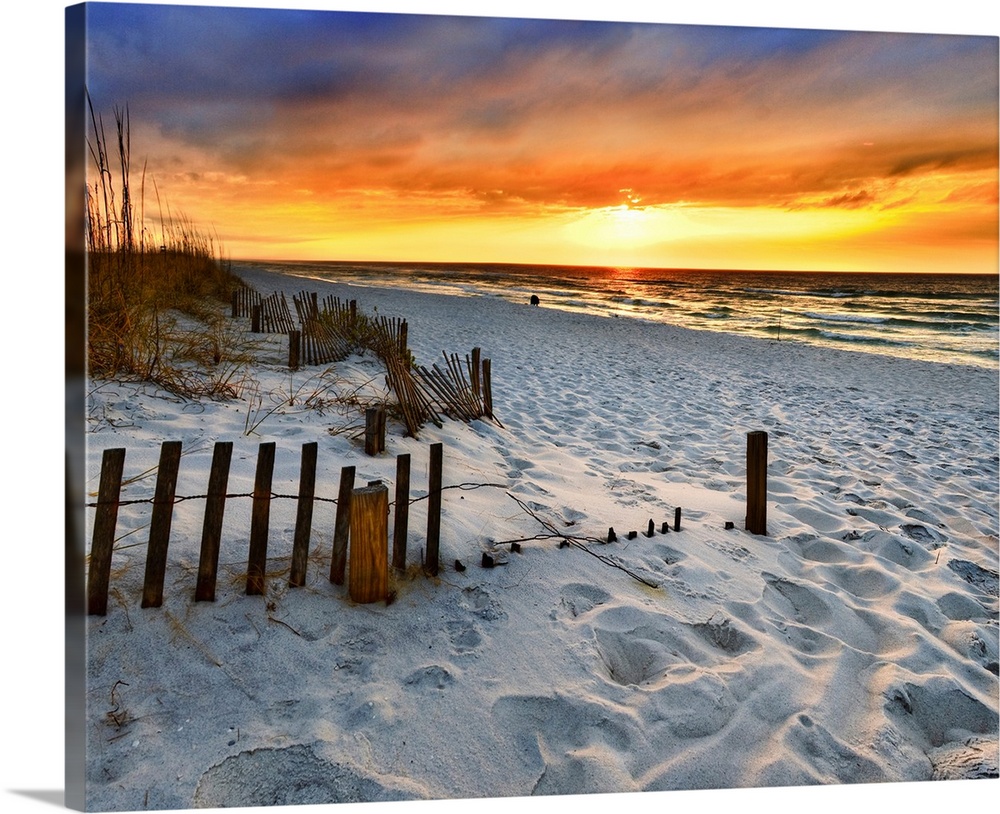A sandy beach before a bright red sunset on the beach. The sand in This part of Florida is bright white. Landscape taken o...