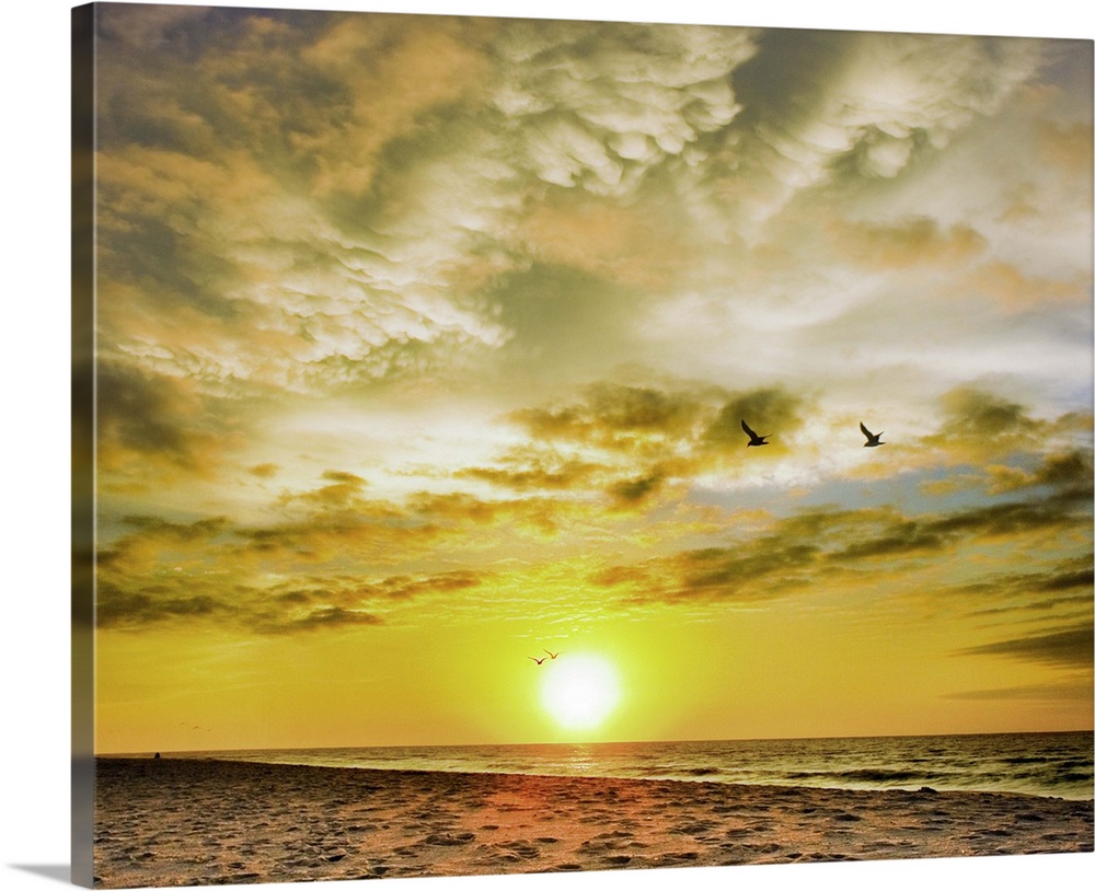 A beautiful Destin Beach Sunrise with orange and white clouds.