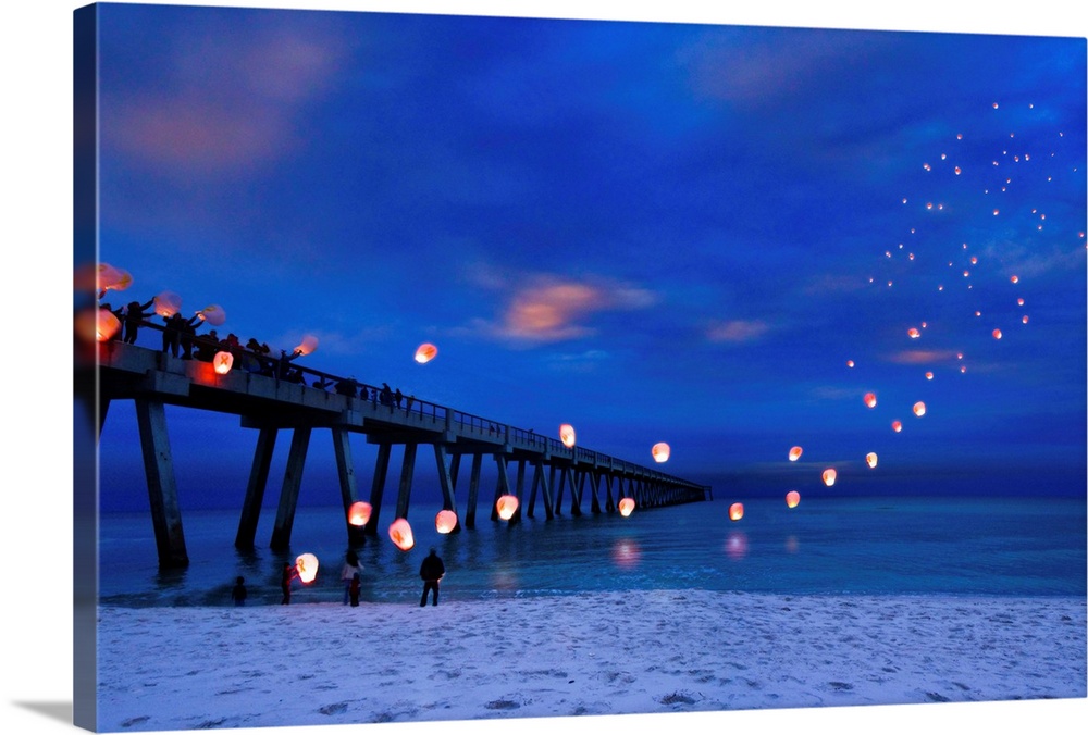 Residents are launching paper lanterns off navarre pier in memory of fallen soldiers on veterans day. Landscape taken on N...