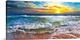 image thumbnail of This panoramic beach sunset features breaking waves on a beautiful sea shore. A wave crashes on the shore before an orange...