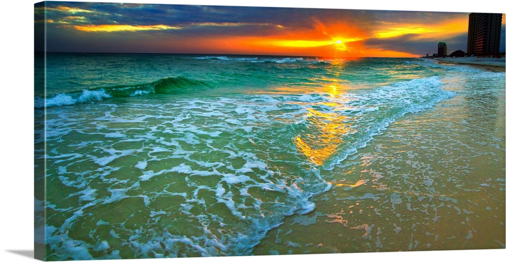 Emerald waves and soft white foam. Dark yellow and red sunset seascape. Landscape taken on Navarre Beach, Florida.