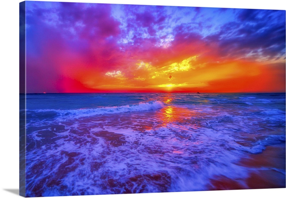 A beautiful colorful blue fiery red and orange ocean sunset on the beach.