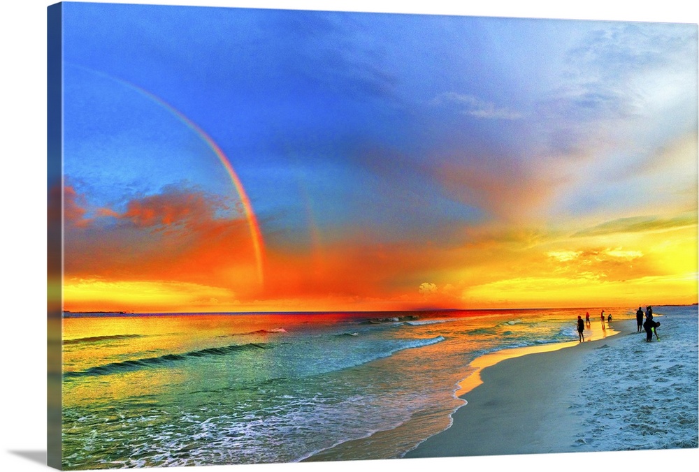 A landscape featuring a rainbow over the beach and green seascape and blue and orange sky. Landscape taken near Navarre Be...
