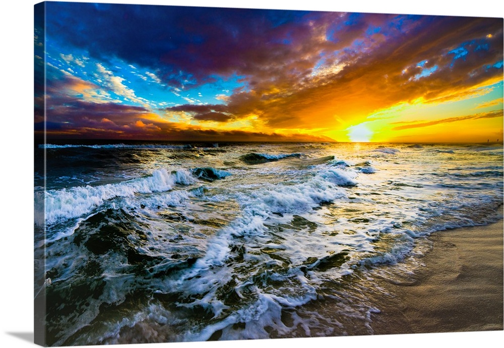 A red and blue sunset on the beach with a turbulent ocean with waves. Strong dark to light contrast in this beautiful ocea...