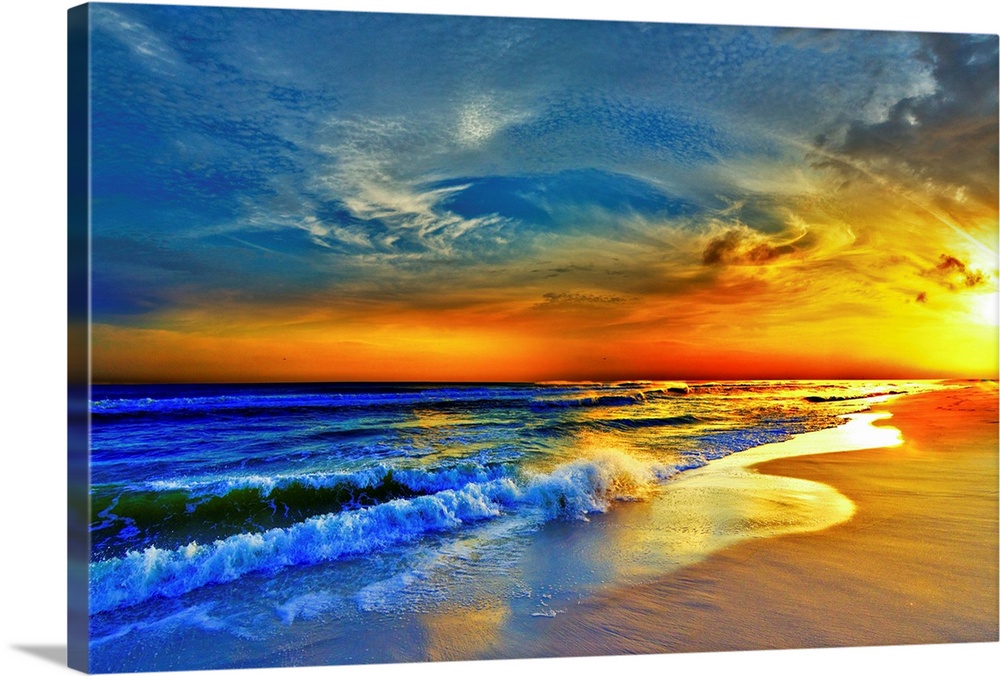 A sandy beach before a bright burning red sunset.  Waves crash onto the sandy sea shore. Landscape taken on Navarre Beach,...