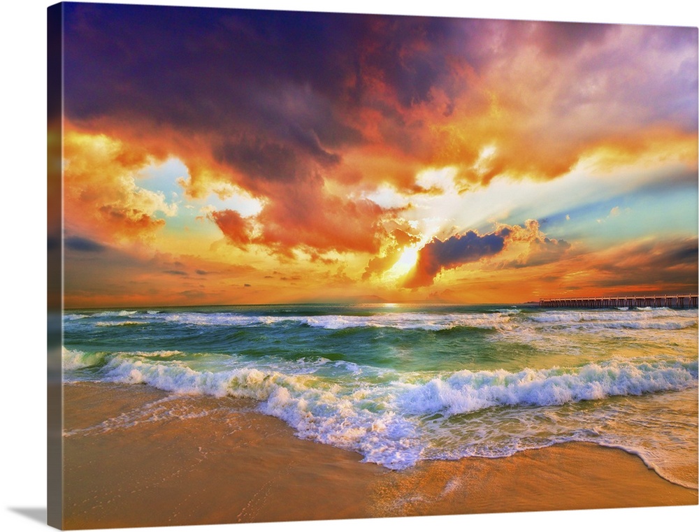 A sandy beach before a bright burning red sunset. Green waves crash onto the sandy sea shore. Landscape taken on Navarre B...