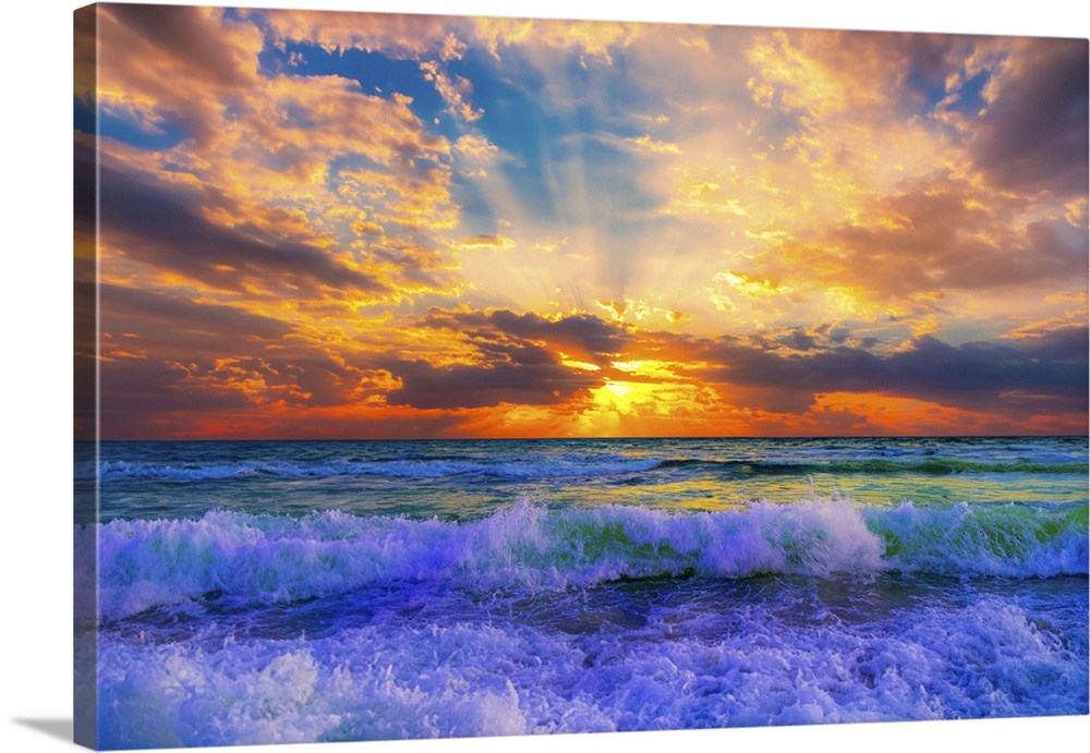 A fruit punch sun kissed orange sunset with sunrays illuminate the soft pink clouds. Blue waves break the green sea.