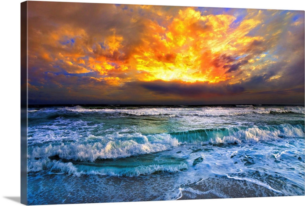 A dark red and orange sunset over ocean waves. This red sunset has a beautiful ocean view with a turquoise sea.