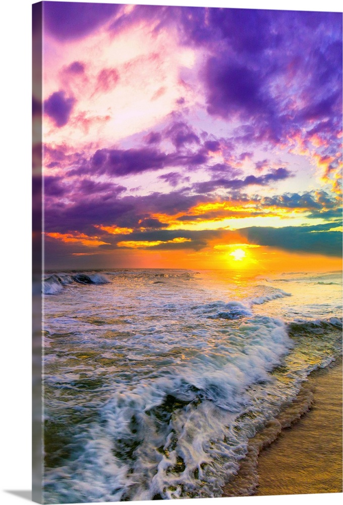 A pink and purple beach sunset over the ocean. The expansive vertical sky is excellent for a vertical sunset image.