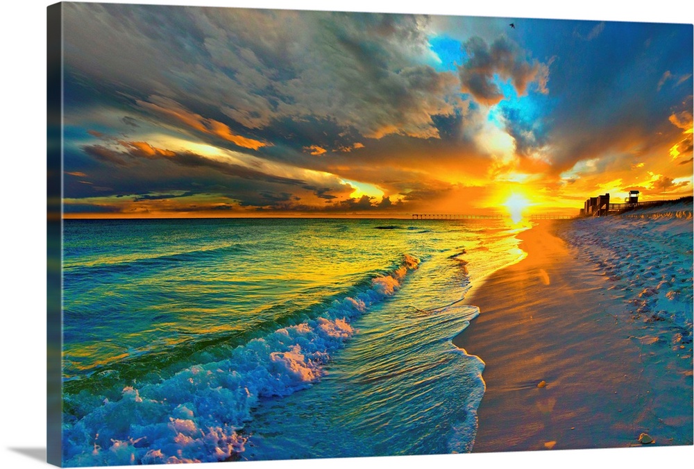 Image of waves crashing before a dark yellow and blue sunset seascape over an emerald green seascape and beach. Landscape ...
