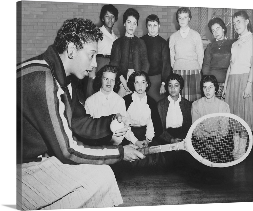 Althea Gibson, speaks to young women attending a tennis clinic at Midwood High in Brooklyn. Dec. 1957. Earlier in the year...