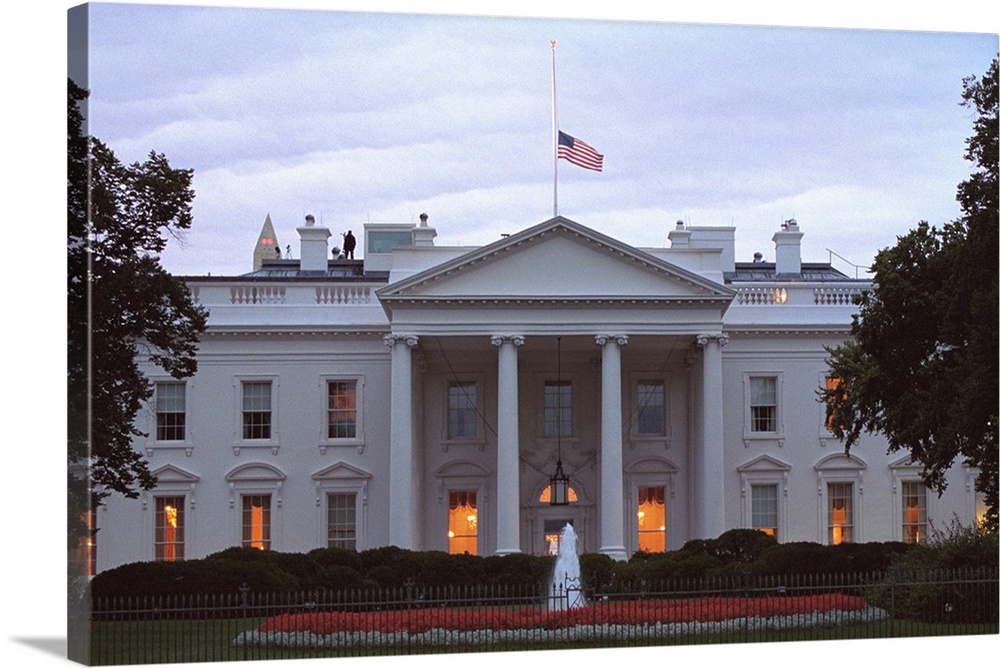 American flag flies at half-staff over the White House at sunrise Friday, Sept. 14, 2001. 3 days following the 9-11 Terror...