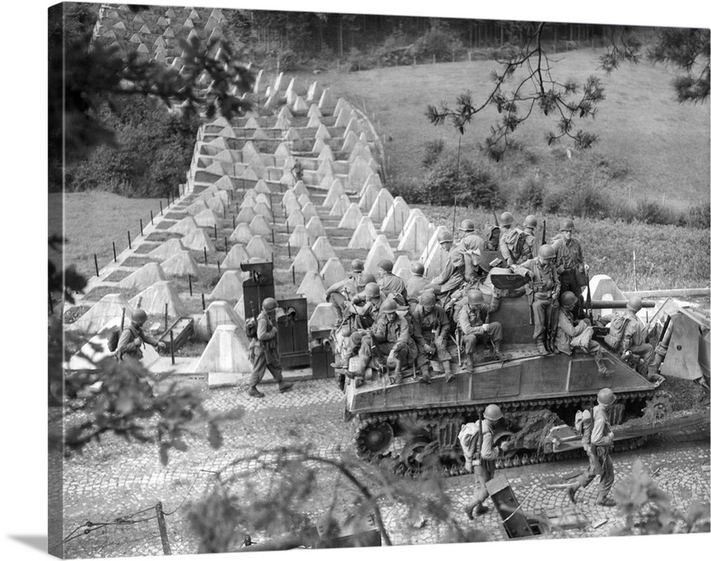 Americans roll through Siegfried Line on a 'tank dozer' near Roetgen, Germany, on Sept. 28, 1944. Roetgen was the first Ge...