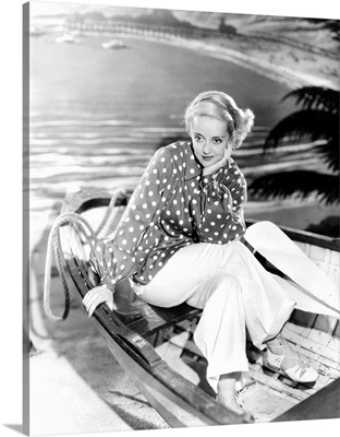 Bette Davis, modeling a red and white beach ensemble, 1935