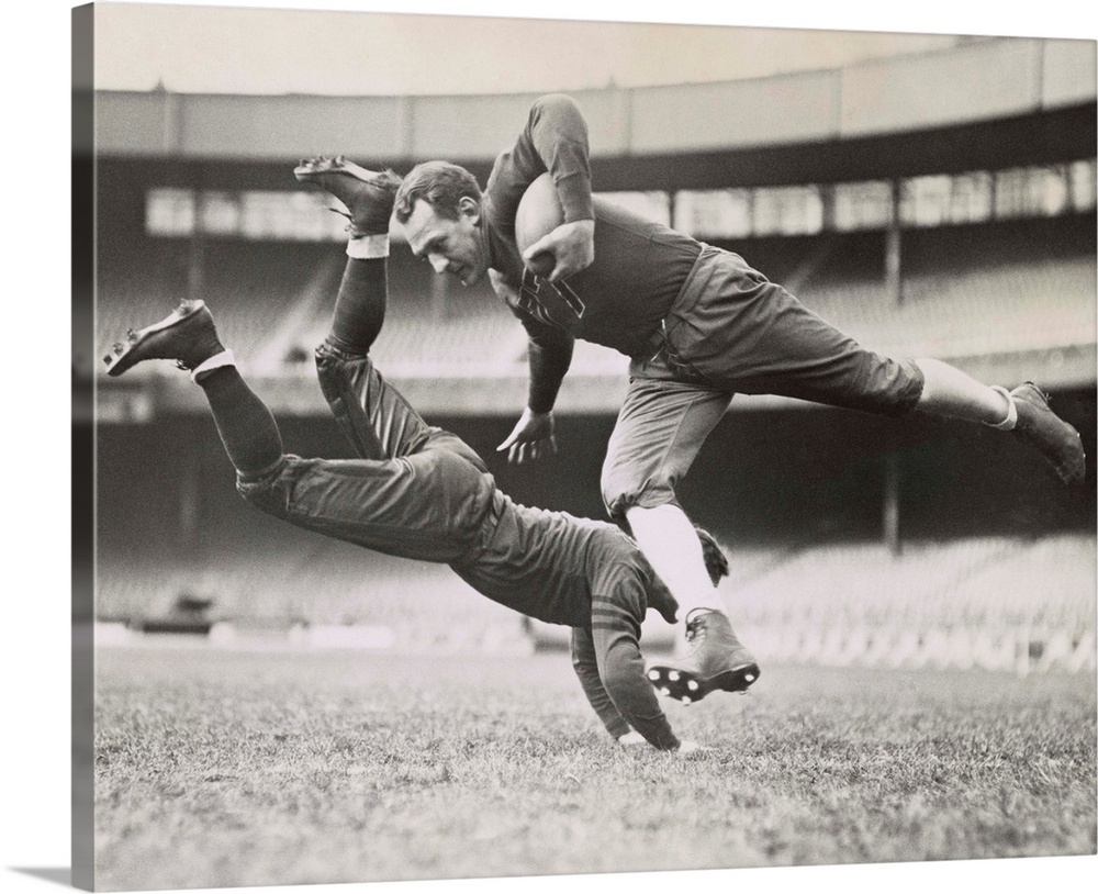 Chicago Bears teammates practicing as Joe Zeller tries to tackle Red Grange. March 18, 1935.
