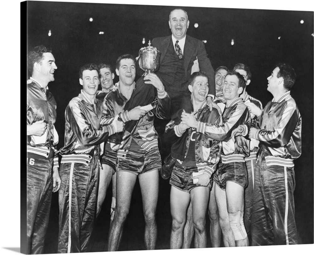 Coach Adolph Rupp on the shoulders of Kentucky Wildcats basketball team. They had just won the National Invitational Baske...
