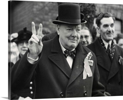 Conservative Party Leader Winston Churchill gives his familiar victory sign