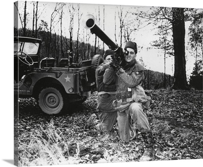 Elvis Presley training with a bazooka while on maneuvers in Germany