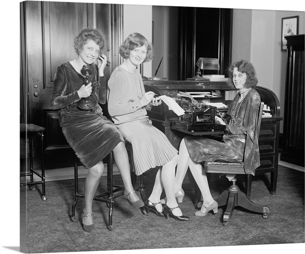 Fashionable young women in a Washington, D.C. office, May 1, 1929. One holds a telephone, another a stenographic pad, and ...