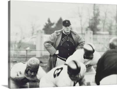Football coach Earl 'Red' Blaik, oversees his players as they practice, Nov, 28, 1956