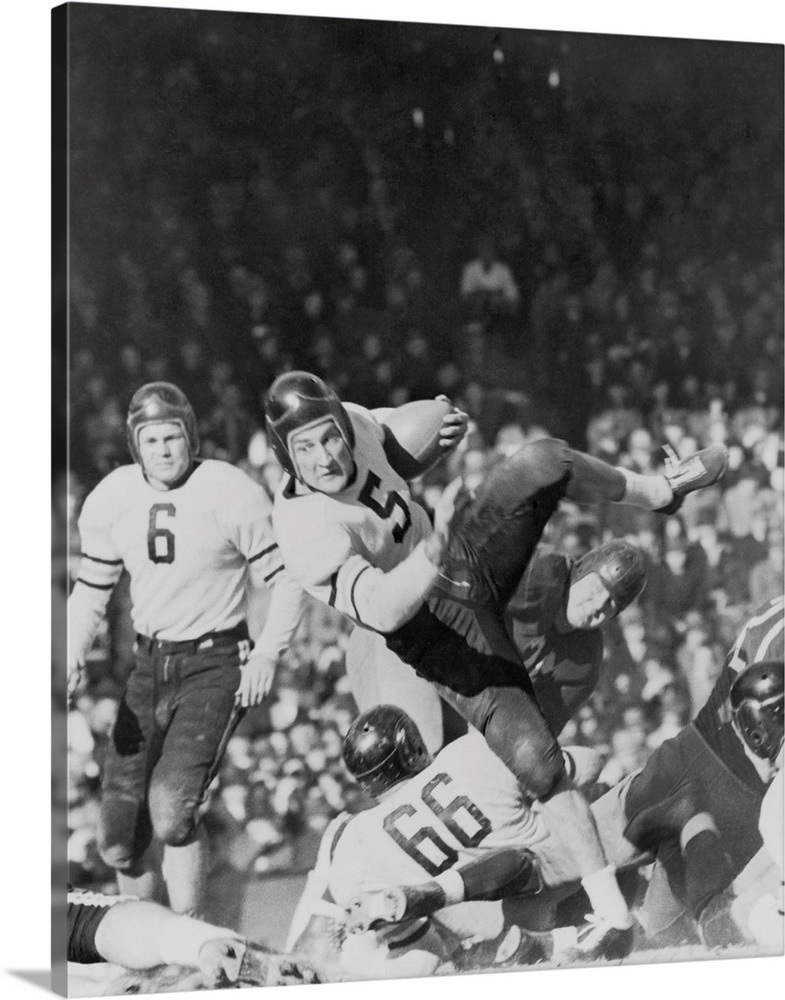 George McAfee, Chicago Bears back, sliding off Washington Redskins tackle for seven yards. 1940. He played for the Chicago...