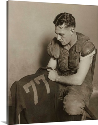 Harold 'Red' Grange holding his football jersey number