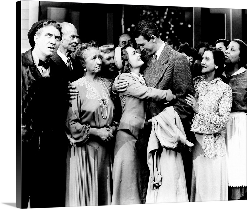 IT'S A WONDERFUL LIFE, foreground from left: Frank Faylen, H.B. Warner, Sarah Edwards, Donna Reed, James Stewart, Beulah B...