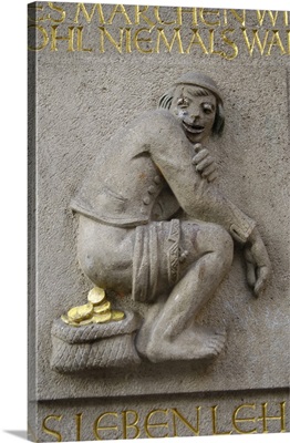 Jocular statue on the facade of a bank in the old town. Dusseldorf, Germany