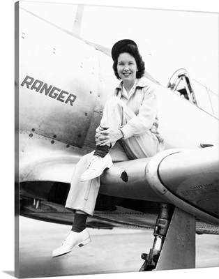 Margaret McGrath, former WASP sitting on the wing of in an XAT-6E trainer aircraft