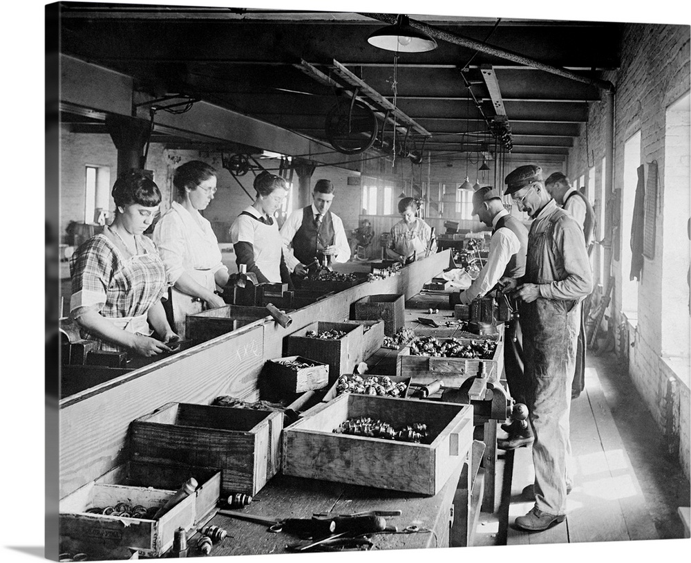 Men and Women working on an assembly line in the Express Spark Plug Co. Ca. 1920, in the Washington, D.C. area.