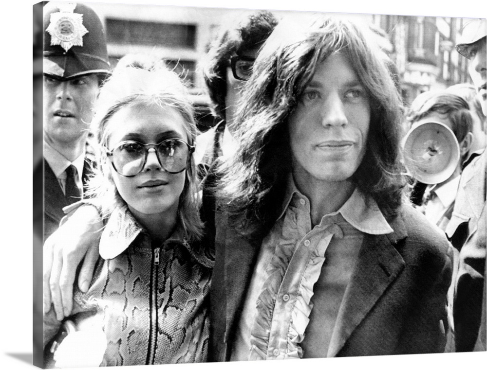 Mick Jagger and his girl friend, singer Marianne Faithful arrive at Magistrate's Court. The couple faced charges of posses...