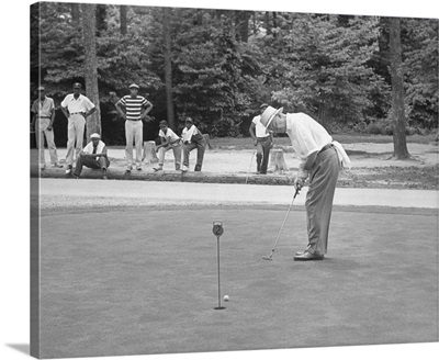 President Dwight Eisenhower on a putting green of a golf course, August 1957