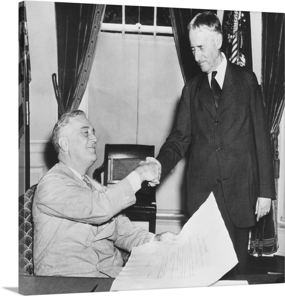 President Franklin Roosevelt shaking hands with his new Secretary of War, Republican Henry Stimson. July 10, 1940. FDR est...