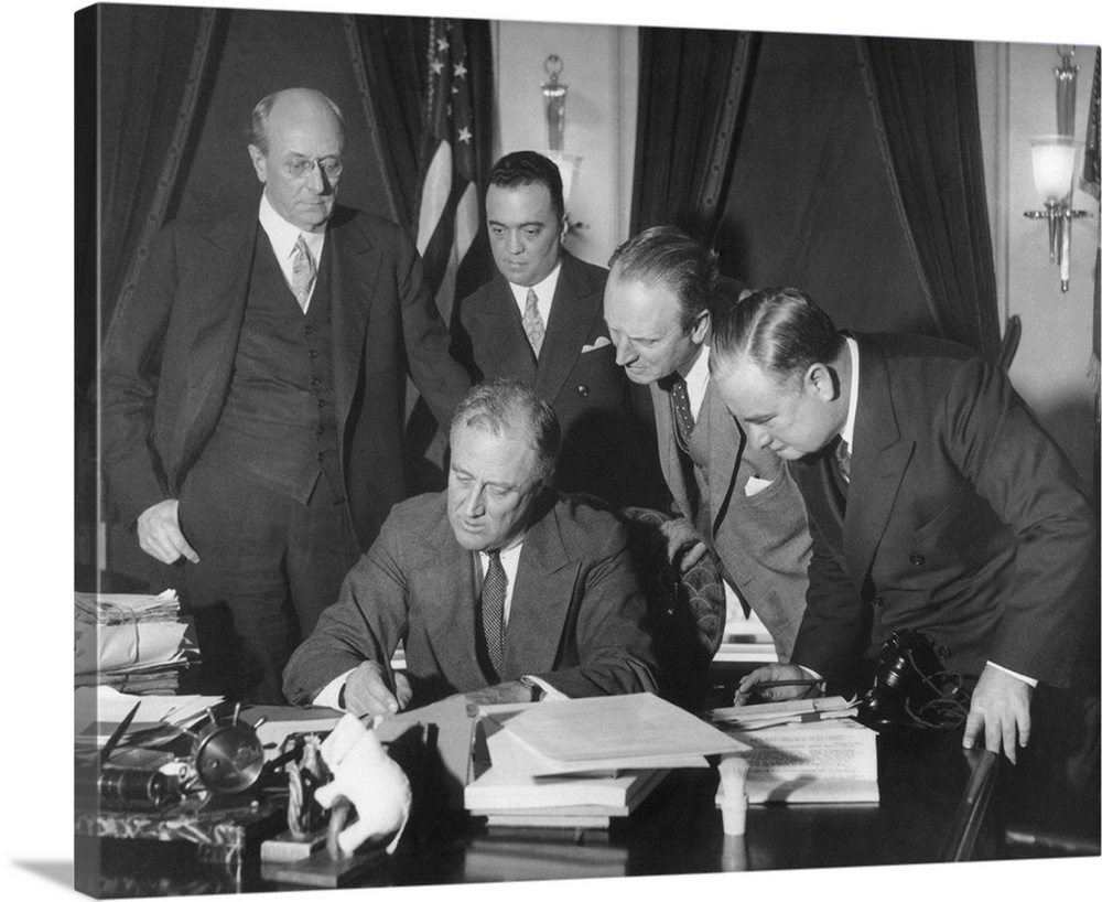President Franklin Roosevelt signing the 1934 crime bill into law. Looking on from left: Attorney General Homer Cummings; ...