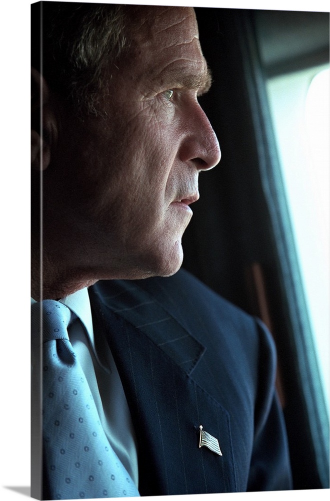 President George W. Bush surveys the damage to the Pentagon from Marine One, Sept. 14, 2001. Three days after the 9-11 Ter...