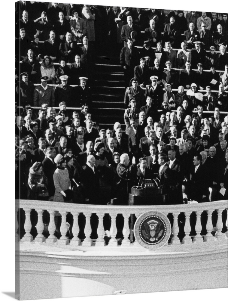 President John Kennedy takes the oath of office administered by Chief Justice Earl Warren. Jan. 20, 1961.