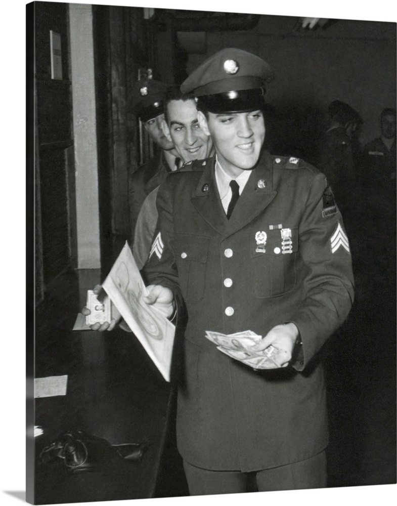 Sgt. Elvis A. Presley, 32nd Armored, 3rd Armored Div. collecting his last pay as he re-enters civilian life. March 5, 1960.